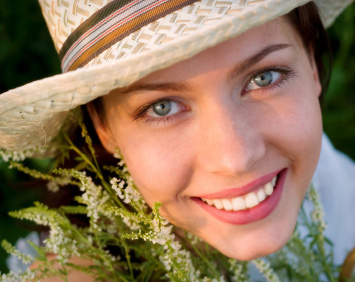 A woman smiles after she is finished with her root canal treatment in Midland, TX