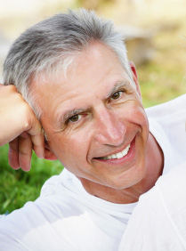 A man showing off his dental implants in Midland, TX.